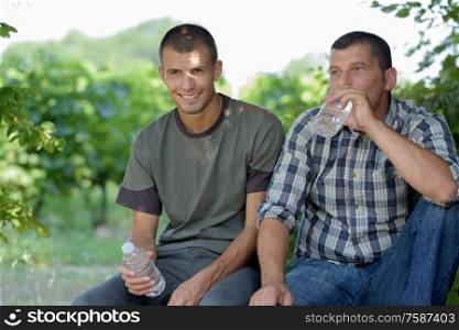 portrait of two vineyard workers having a break