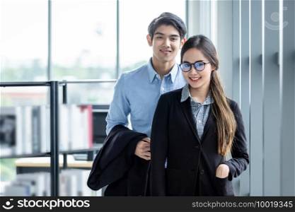 Portrait of two wear glasses businessman and businesswoman partners discussing attractive positive business expressed confidence embolden and successful concept,Working couple