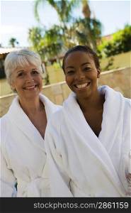 Portrait of two women in bathrobes at health spa