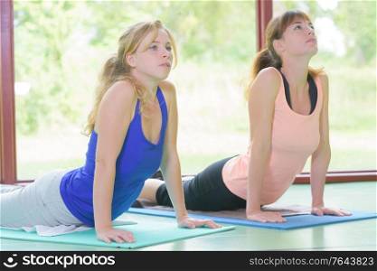 portrait of two women practicing yoga