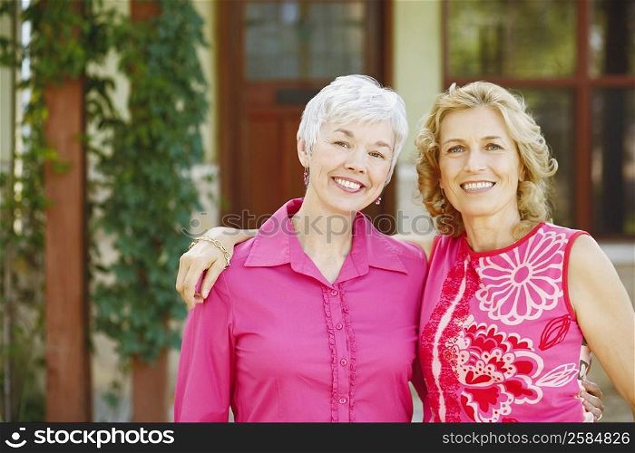 Portrait of two women standing together and smiling