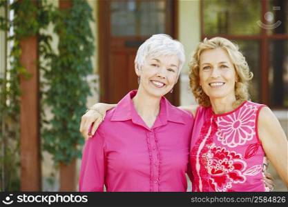 Portrait of two women standing together and smiling
