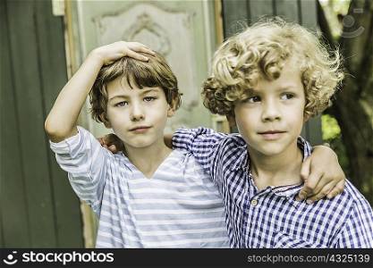 Portrait of two young brothers in garden
