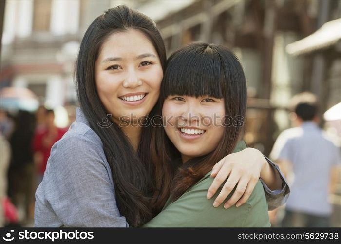 Portrait of two young friends in Beijing outdoors
