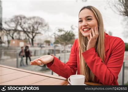 Portrait of two young friends spending good time together while sitting at coffee shop. Lifestyle and friendship concept.