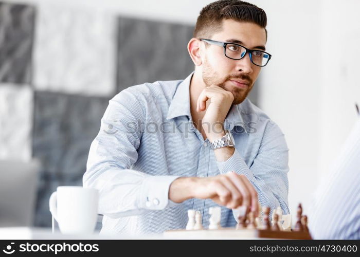 Portrait of two young man playing chess . Portrait of two young man playing chess in office