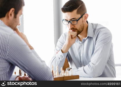 Portrait of two young man playing chess . Portrait of two young man playing chess in office