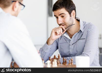 Portrait of two young man playing chess . Portrait of two young man playing chess in office