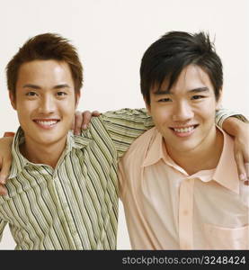 Portrait of two young men and a mid adult man posing and smiling