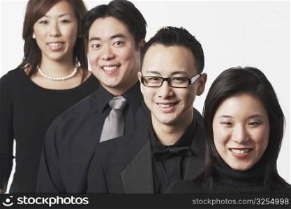 Portrait of two young men and two young women smiling