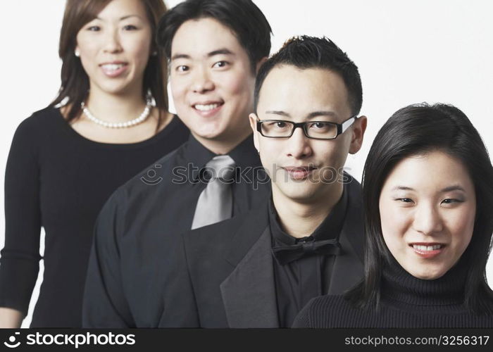 Portrait of two young men and two young women smiling