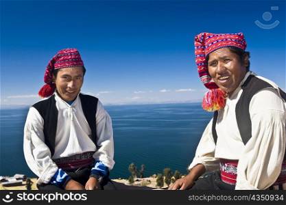 Portrait of two young men sitting, Taquile Island, Lake Titicaca, Puno, Peru