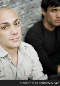 Portrait of two young men sitting together