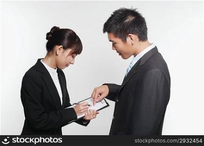 Portrait of two young people in business suit talking