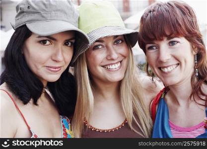 Portrait of two young women and a mid adult woman smiling