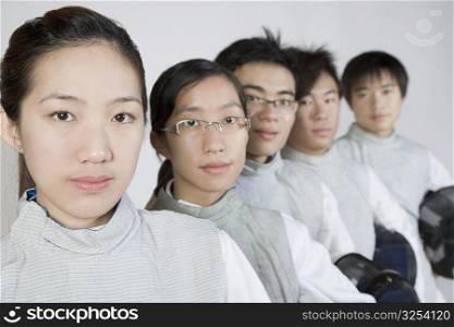 Portrait of two young women and three young men in a row