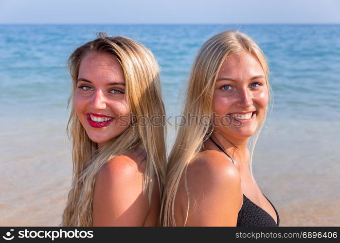 Portrait of two young women as friends at sea