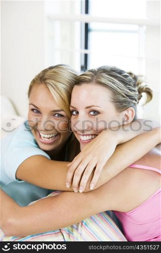 Portrait of two young women hugging each other
