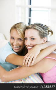 Portrait of two young women hugging each other