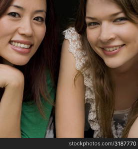 Portrait of two young women smiling together