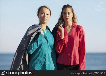 Portrait of two young women standing on the beach