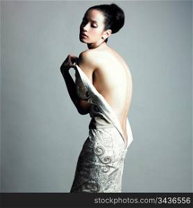 Portrait of undress elegant woman. Studio fashion photo.