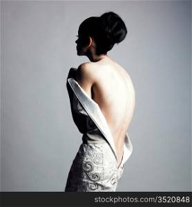 Portrait of undress elegant woman. Studio fashion photo.