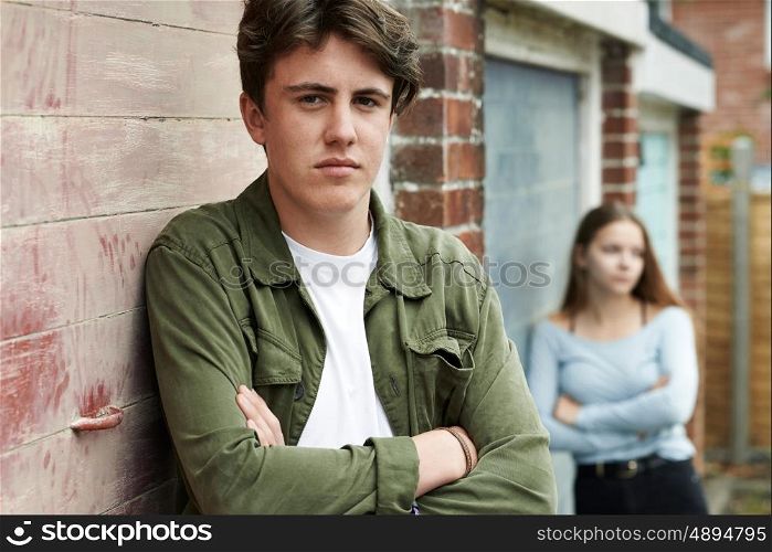 Portrait Of Unhappy Teenage Couple In Urban Setting