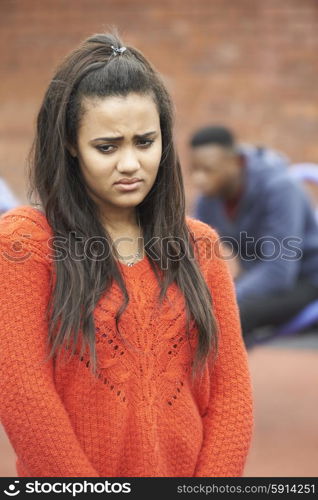 Portrait Of Unhappy Teenage Couple In Urban Setting