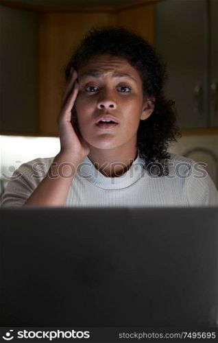 Portrait Of Unhappy Woman At Home With Computer Being Bullied Online On Social Media