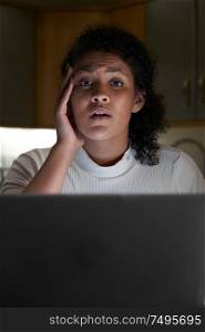 Portrait Of Unhappy Woman At Home With Computer Being Bullied Online On Social Media