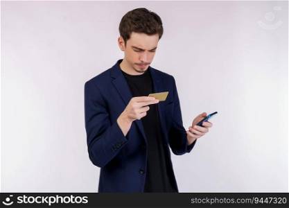 Portrait of unhappy young businessman standing using mobile cell phone and holding credit bank card isolated on white color background studio.