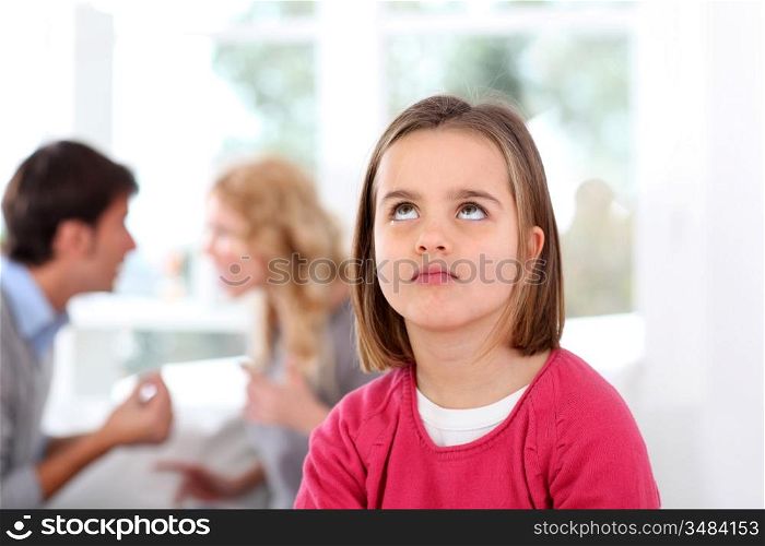 Portrait of upset child with parent&acute;s fighting