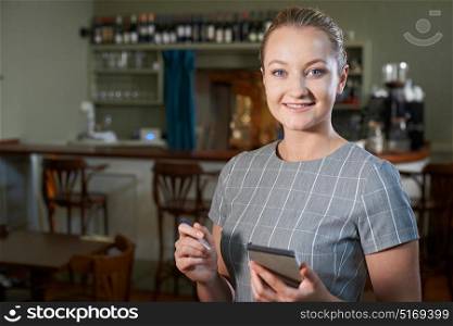 Portrait Of Waitress With Notepad In Restaurant