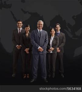 Portrait of well-dressed business people smiling on black background