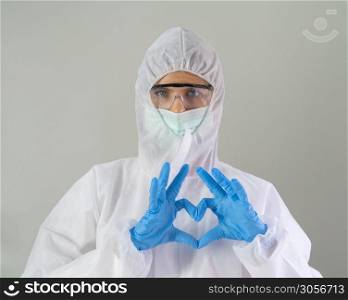 Portrait of western scientist or doctor woman with Covid-19 suit and mask working at hospital on grey background in medical health care and corona virus pandemic concept.