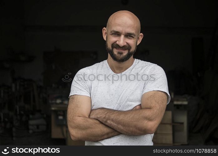 Portrait Of white bald carpenter with beard in white t-shirt. isolate on a black background