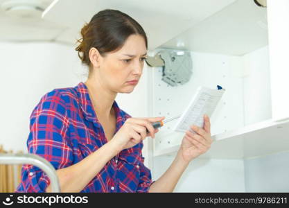 portrait of woman assembling furniture