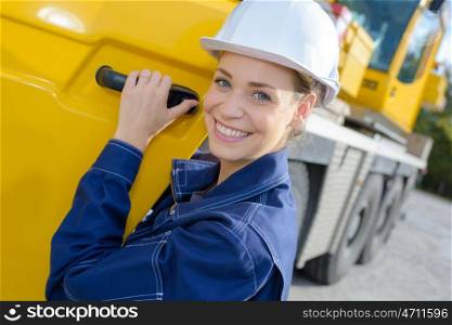 Portrait of woman at cab of heavy plant vehicle
