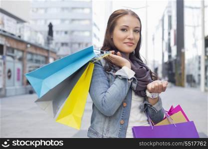 Portrait of woman carrying shopping bags