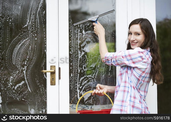 Portrait Of Woman Cleaning House Windows