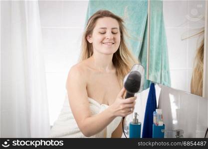 Portrait of woman covering in bath towel drying hair