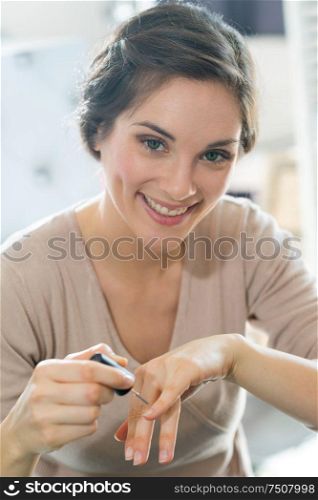 portrait of woman doing her nails