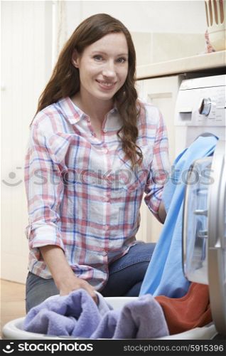 Portrait Of Woman Doing Laundry At Home