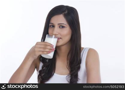 Portrait of woman drinking glass of milk