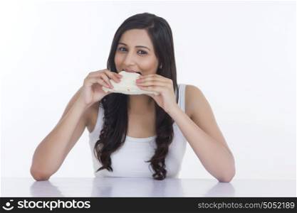 Portrait of woman eating a sandwich