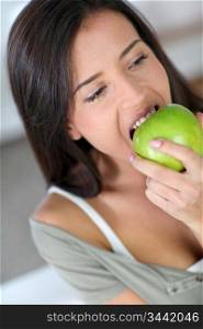 Portrait of woman eating an apple