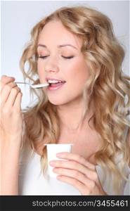 Portrait of woman eating yogurt