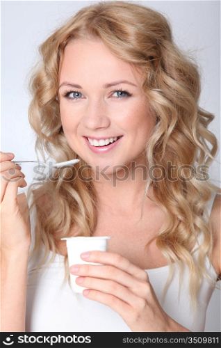 Portrait of woman eating yogurt