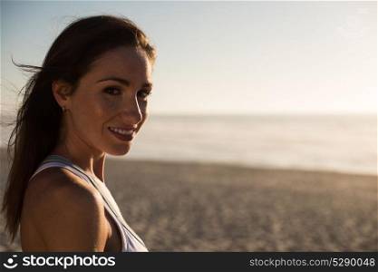 Portrait of woman enjoying beautiful sunset on the beach